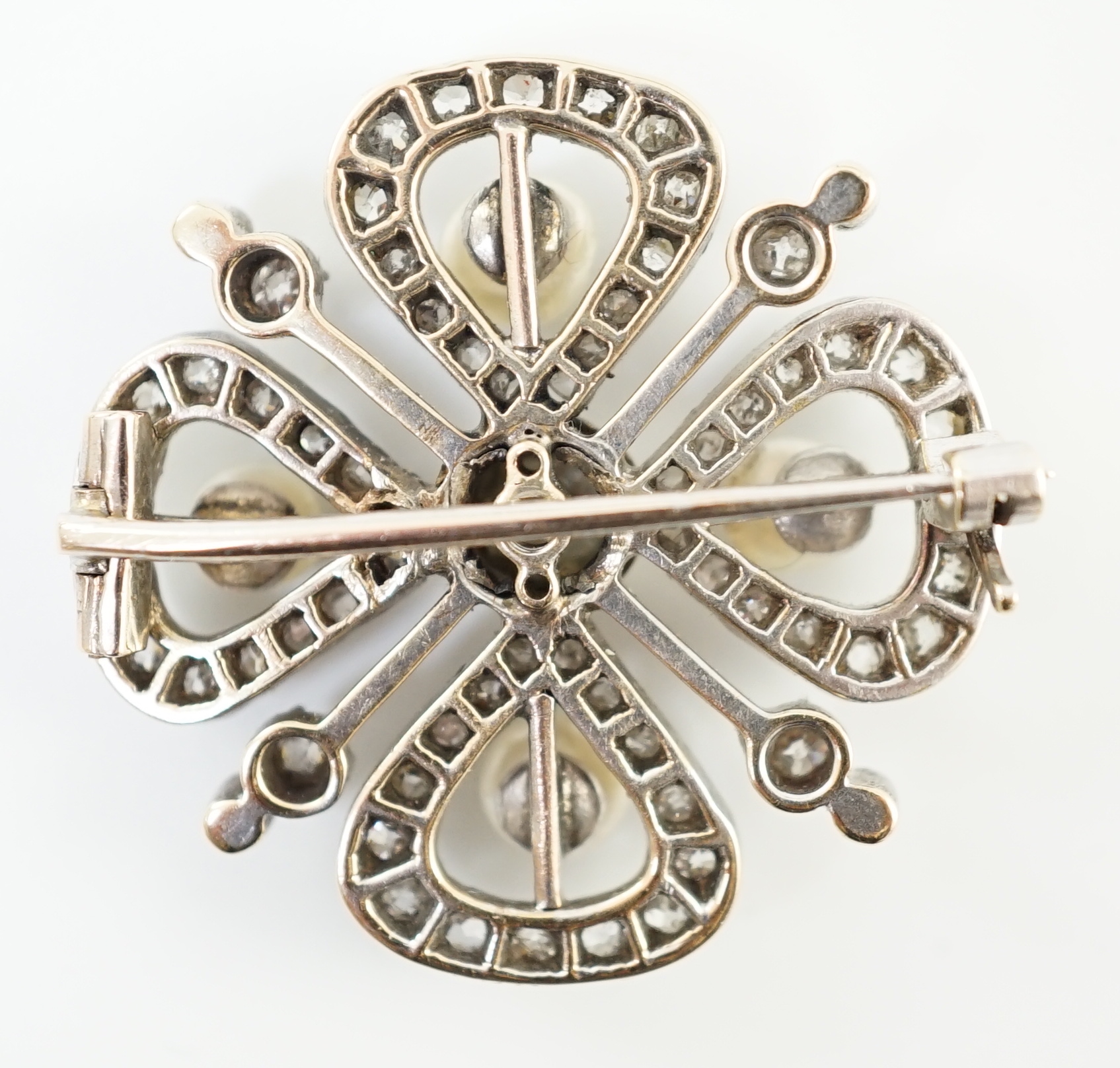An Edwardian gold and platinum, diamond and four stone button pearl cluster set 'clover' brooch